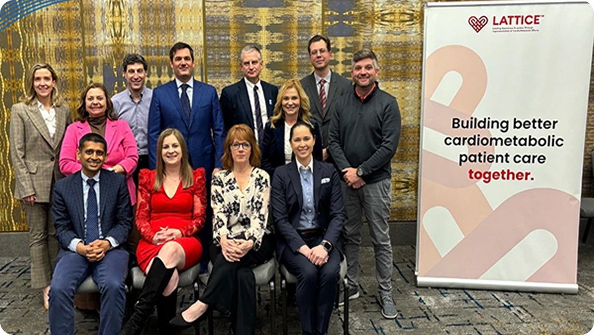 Group of LATTICE™ members beside a banner reading "Building better cardiometabolic patient care together," at ACC25