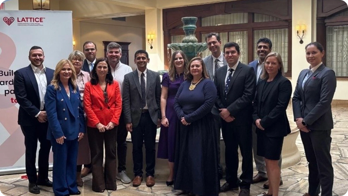 Group of LATTICE™ members in a lobby beside a LATTICE™ banner, at AHA25