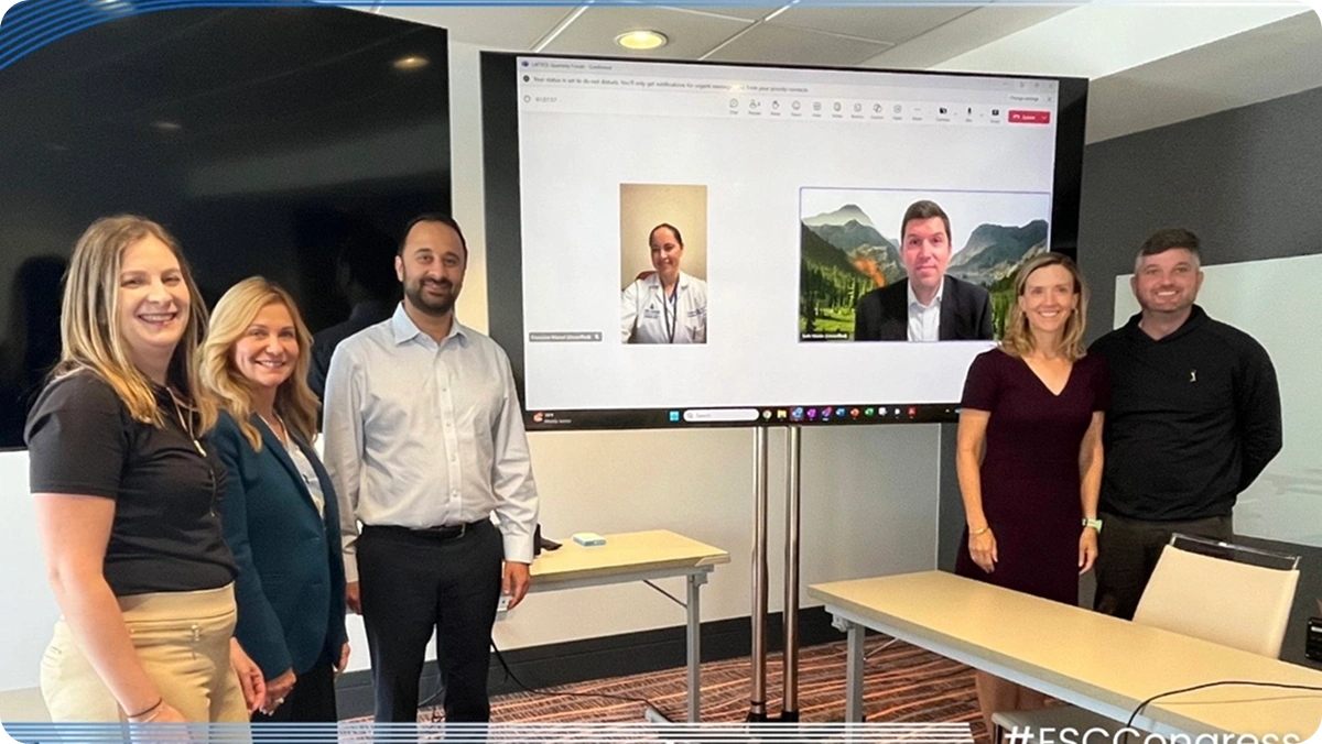 Five LATTICE™ members beside a screen displaying a video call, at ESC Congress