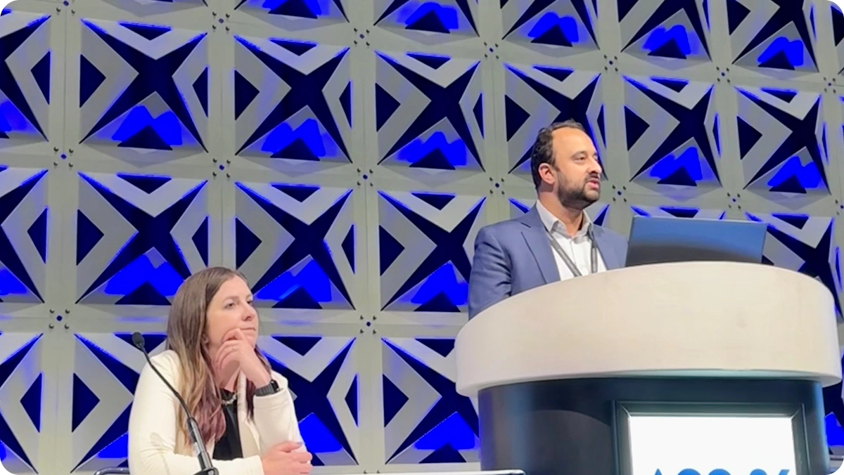Two speakers on stage at the ACC26 podium